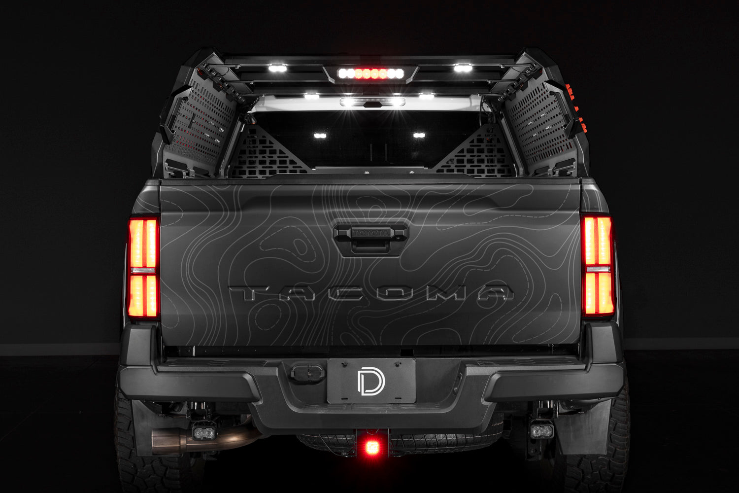 Diode Dynamics IBEX bed rack lighting kit installed on a Toyota Tacoma with bed lights, brake and reverse lit