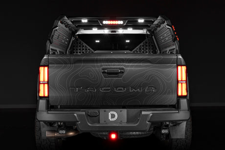 Diode Dynamics IBEX bed rack lighting kit installed on a Toyota Tacoma with bed lights, brake and reverse lit