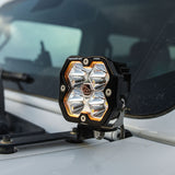 Baja Designs Squadron 2.0 Pro A-Pillar light kit installed on a Jeep Wrangler JL, amber backlight lit