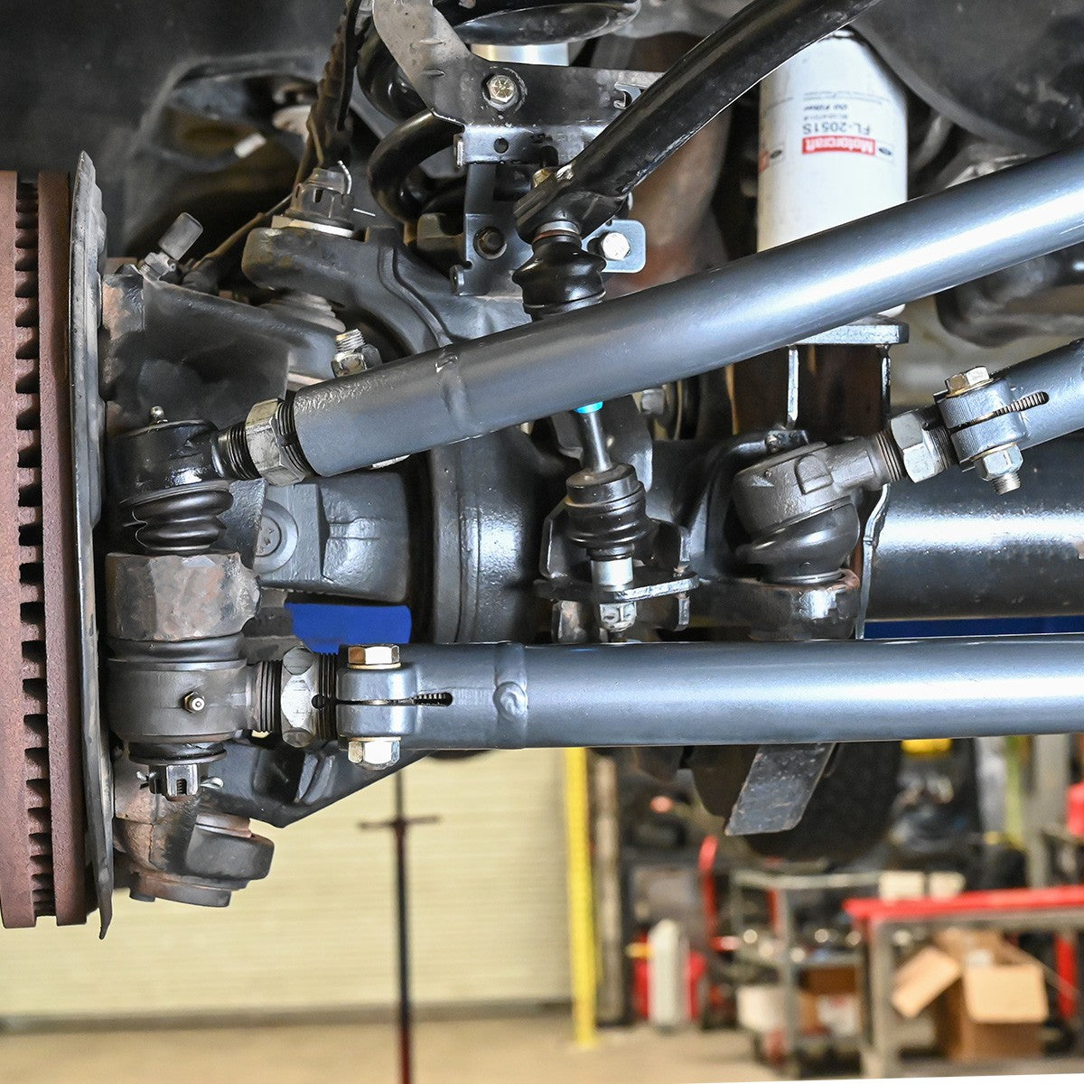 Synergy Manufacturing heavy duty drag link installed under a Ford Super Duty, alternate view