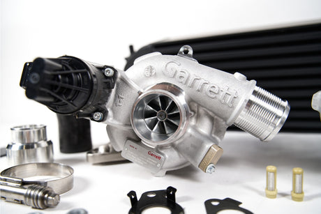 Garrett turbocharger on a white background with car parts.